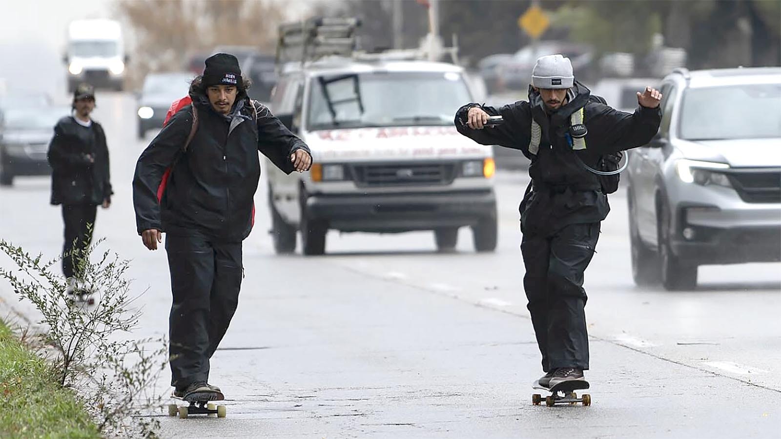 Jason Vanporppal, right, and Gregorio “Orio” Ramirez skate through Pittsfield, Illinois, as part of their cross-country trip from California to New York. The duo hopes to raise enough money on the trip to buy 1,000 skateboards for low-income kids.