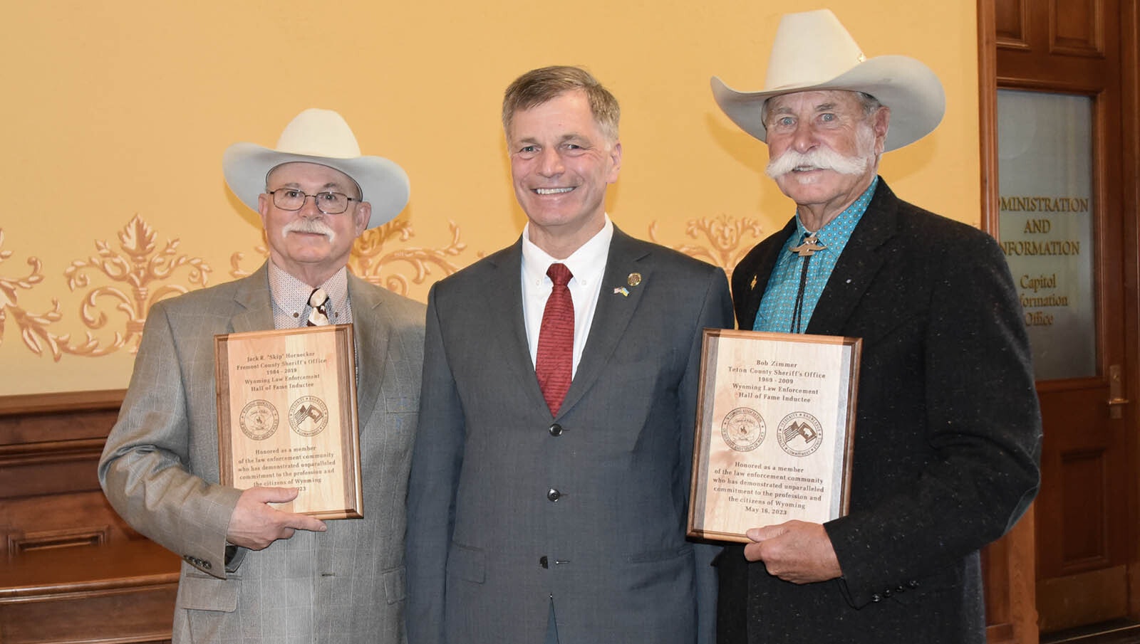Gov. Mark Gordon poses with the newest inductees into the Wyoming Law Enforcement Hall of Fame: Skip Hornecker, left, and Bob Zimmer, right.