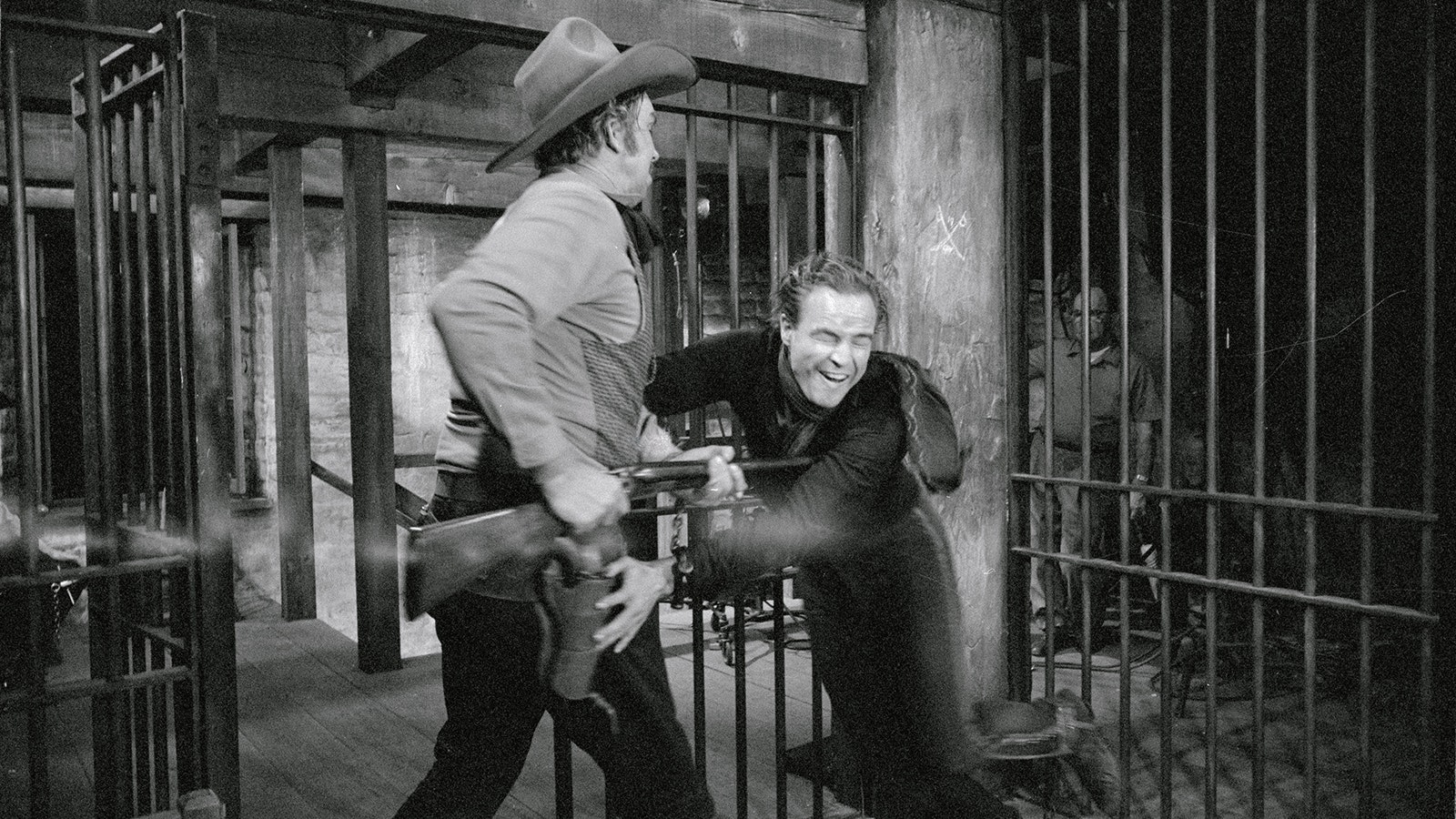 Realism gets too real for actor Marlon Brando in the Pennebaker-Paramount Western "One-Eyed Jacks" as he fights with actor Slim Pickens. Brando, facing the camera, is attempting a jailbreak, is spotted by Pickens, who hits him with the butt of his rifle. In the scuffle, Brando was gashed over the right eye, which required several stitches. Brando, who directed the picture, told the cameraman to print the shot as he did not want the realism lost.