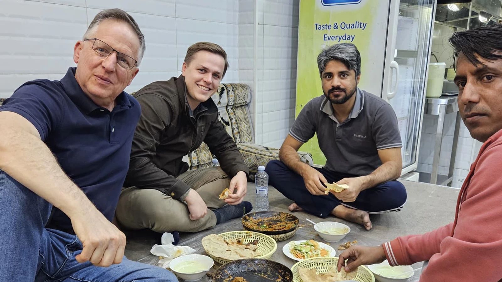 Brian Gross, left, gets dinner with Christian Etheridge Muhammad Usman and Kawsar Miah at an international airport. Gross builds factories around the world.