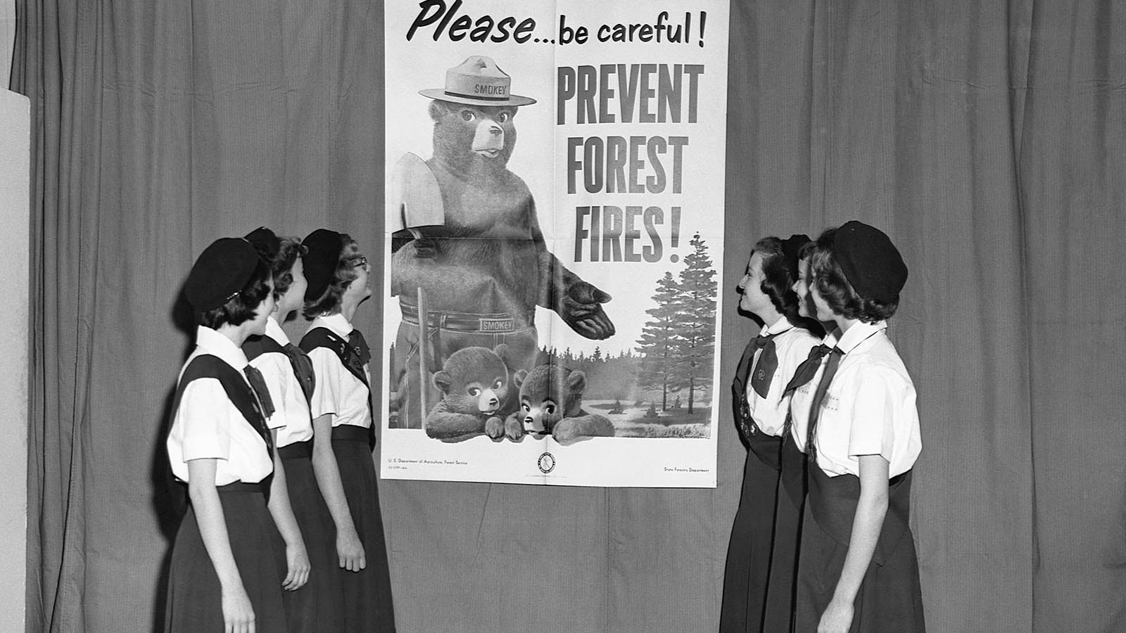 Six Girl Scouts from Troop 4 in Sandy Spring, Maryland, participate in a national celebration of the Girl Scouts' pledge to help Smokey's campaign to prevent man-caused forest fires for the year 1954.