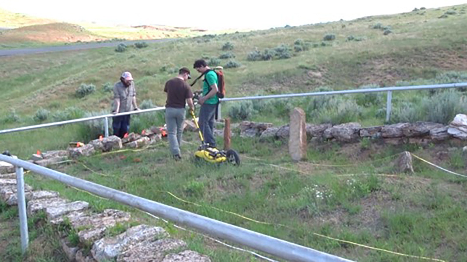 Professor Andy Parsekian and two University of Wyoming Students use a ground penetrating radar to search for disturbances beneath the ground. The three disturbances they found could be a combination of graves and exhumed graves.