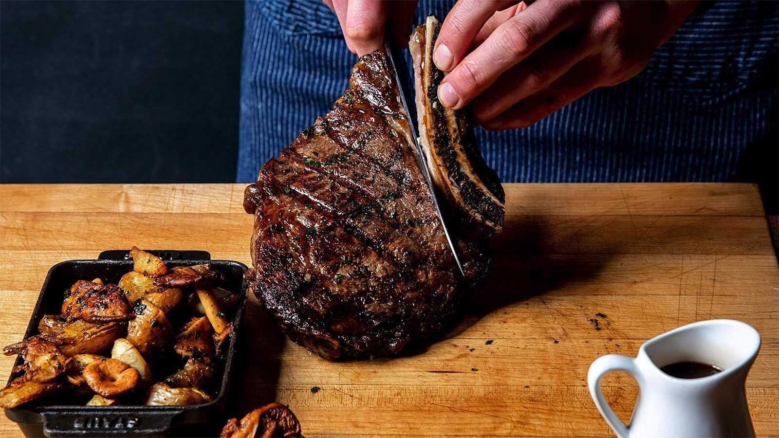 A bone-on ribeye and crispy potatoes.
