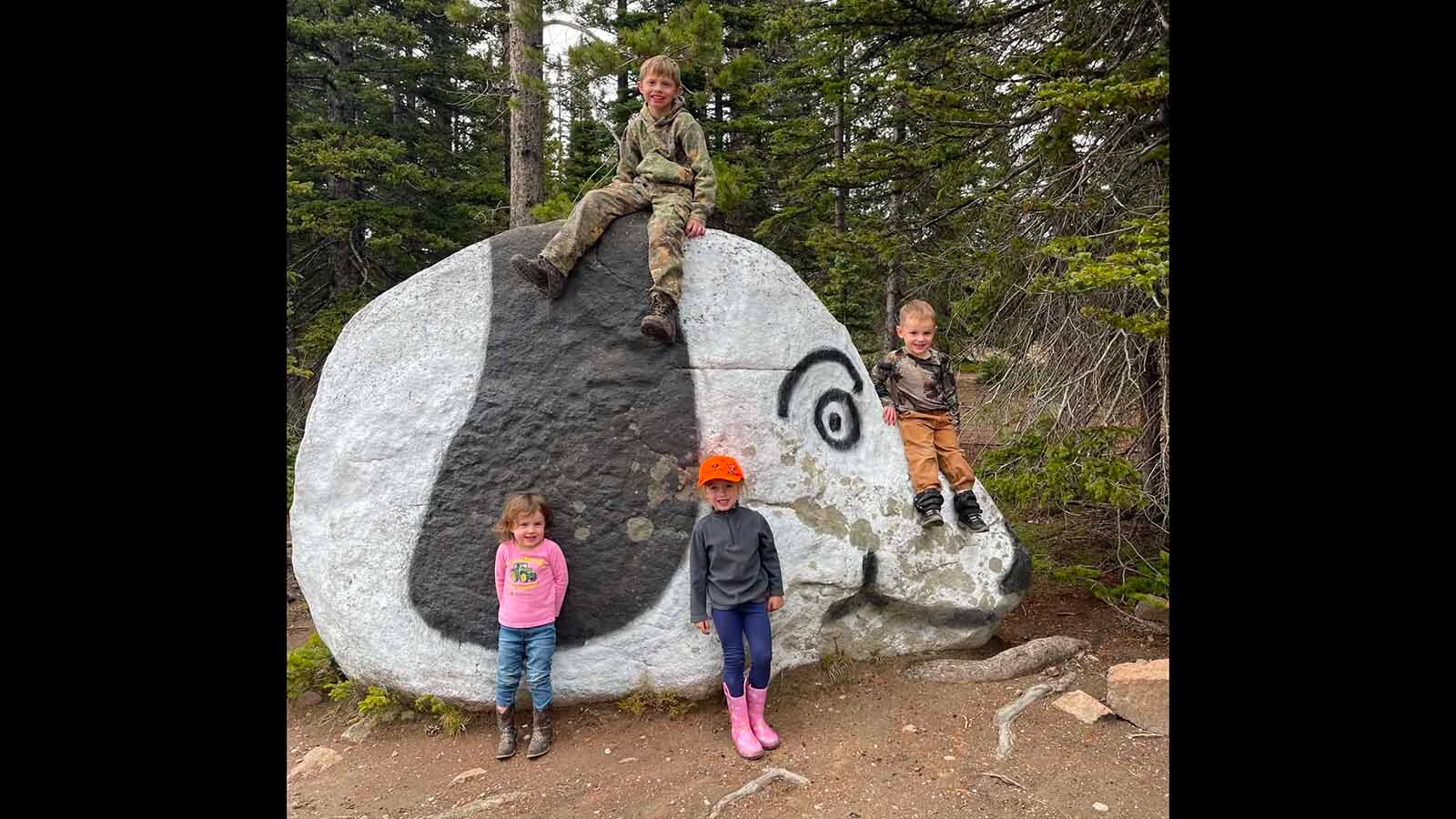 Children pose on and around Snoopy Rock, a longtime local landmark along Forest Service Road 550 in the Sierra Madre between Encampment and Hog Park Reservoir.