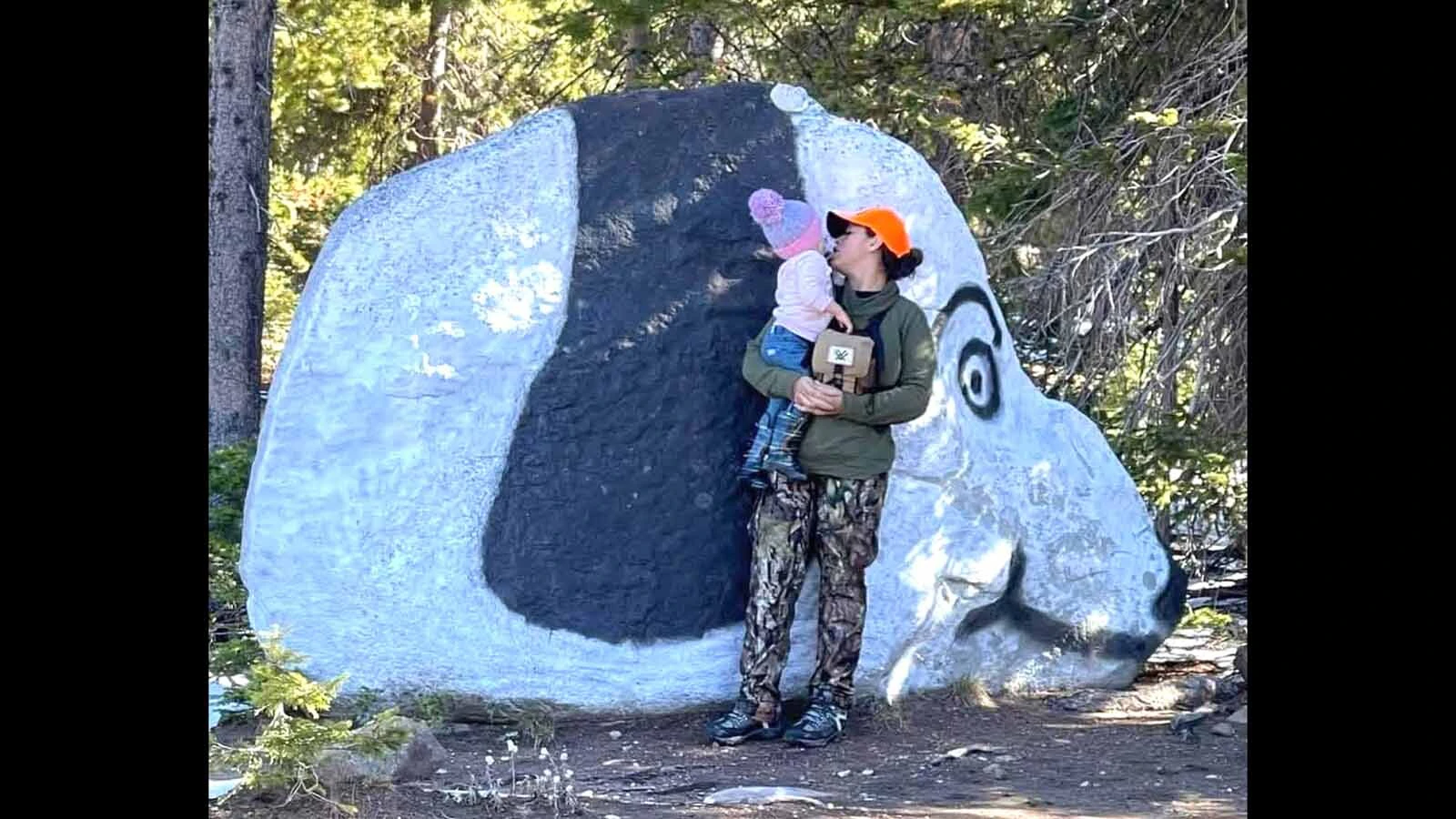 Sade Wilson and her daughter stop at Snoopy Rock during a trip into the Sierra Madre. Wilson has been visiting the area since she was five weeks old and now shares the landmark with the next generation.