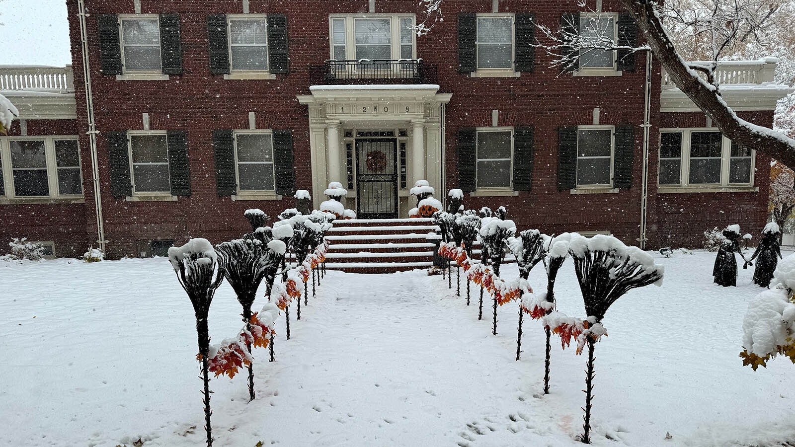 Snow falls across Wyoming, including on the Halloween decorations in yards along Wolcott Street in Casper.