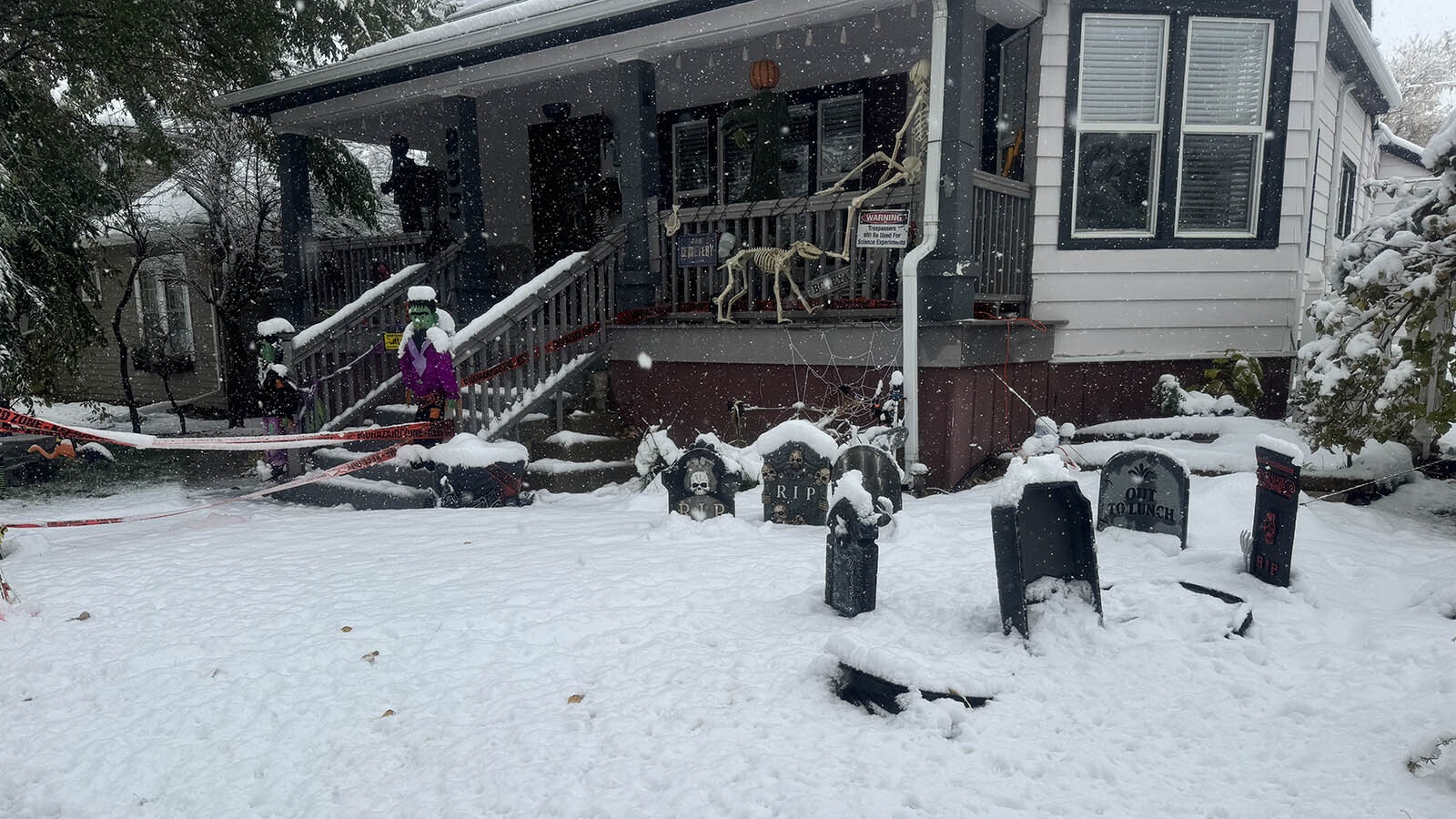 Snow falls across Wyoming, including on the Halloween decorations in yards along Wolcott Street in Casper.