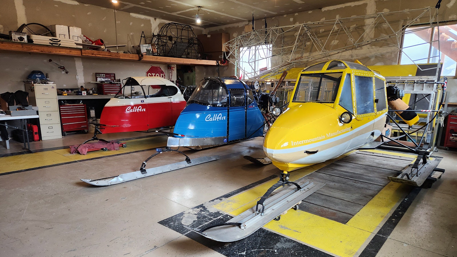 Two CallAir snowplanes (red and blue) in the private collection of Ira Walker in Afton. The Call Aircraft Company created snowplanes as part of a military contract for winter mail delivery through western Wyoming, and they quickly became the most sought-after means of winter travel through Yellowstone and Grand Teton national parks.