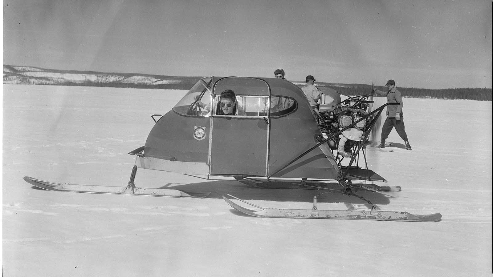 Bob Richard, 18, sticks his head out of the window of a CallAir snowplane. At their top speeds, snowplanes could move at 70 to 100 mph, but stopping them at those speeds was extremely difficult, which is why the best operators of snowplanes were pilots who understood the aircraft components used to built them.