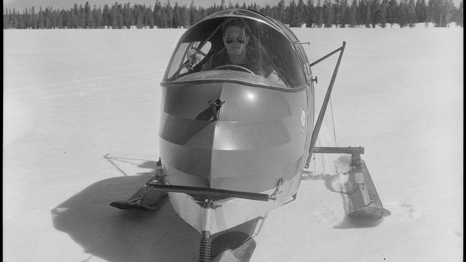 Bob Richard, 18, sits at the helm of a CallAir snowplane. Only two people could sit in the uninsulated cab of a snowplane, so they had to bundle up and brace themselves for the 70-mph trek through the snowy interior and ice-covered lakes of Yellowstone and Grand Teton national parks.