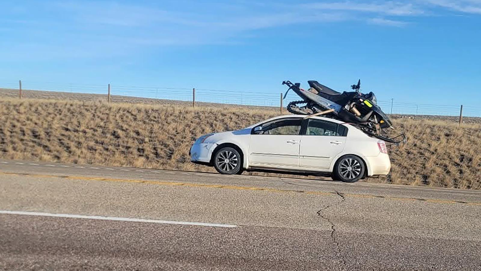 Wyoming drivers gawked at a snowmobile strapped to the a broken-down Nissan Altima on Highway 26 near Casper over the weekend. The jerry-rigged setup failed and a friend's truck came to haul both the car and snowmobile away.