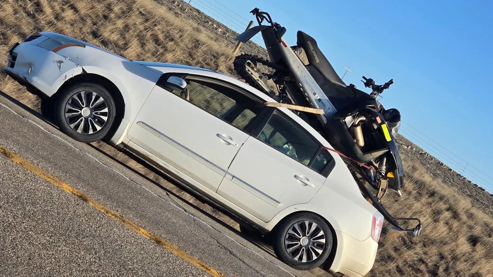 Wyoming drivers gawked at a snowmobile strapped to the a broken-down Nissan Altima on Highway 26 near Casper over the weekend. The jerry-rigged setup failed and a friend's truck came to haul both the car and snowmobile away.