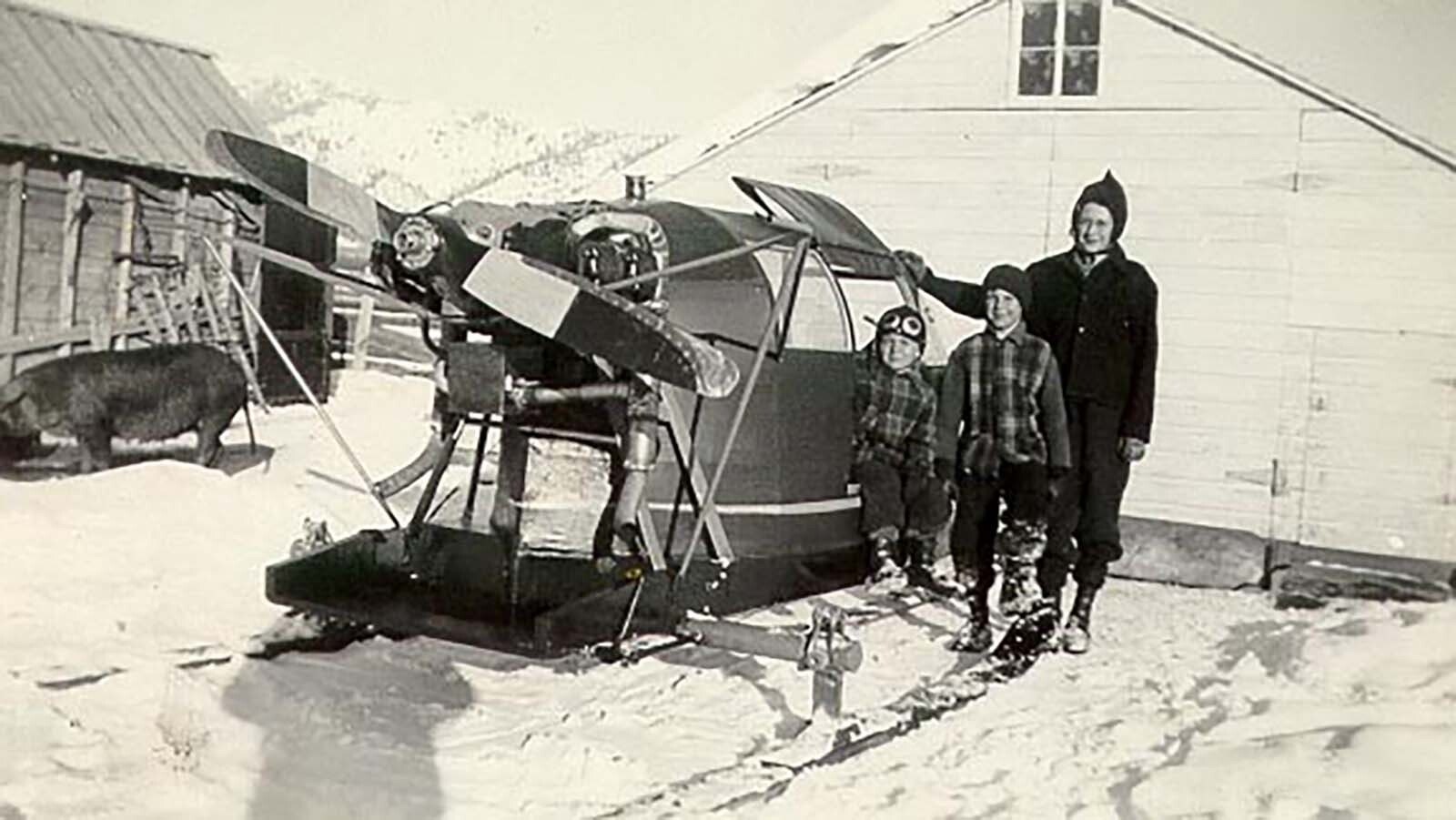 H.L. Wiese and his sons with a snowplane that had an enclosed cockpit.