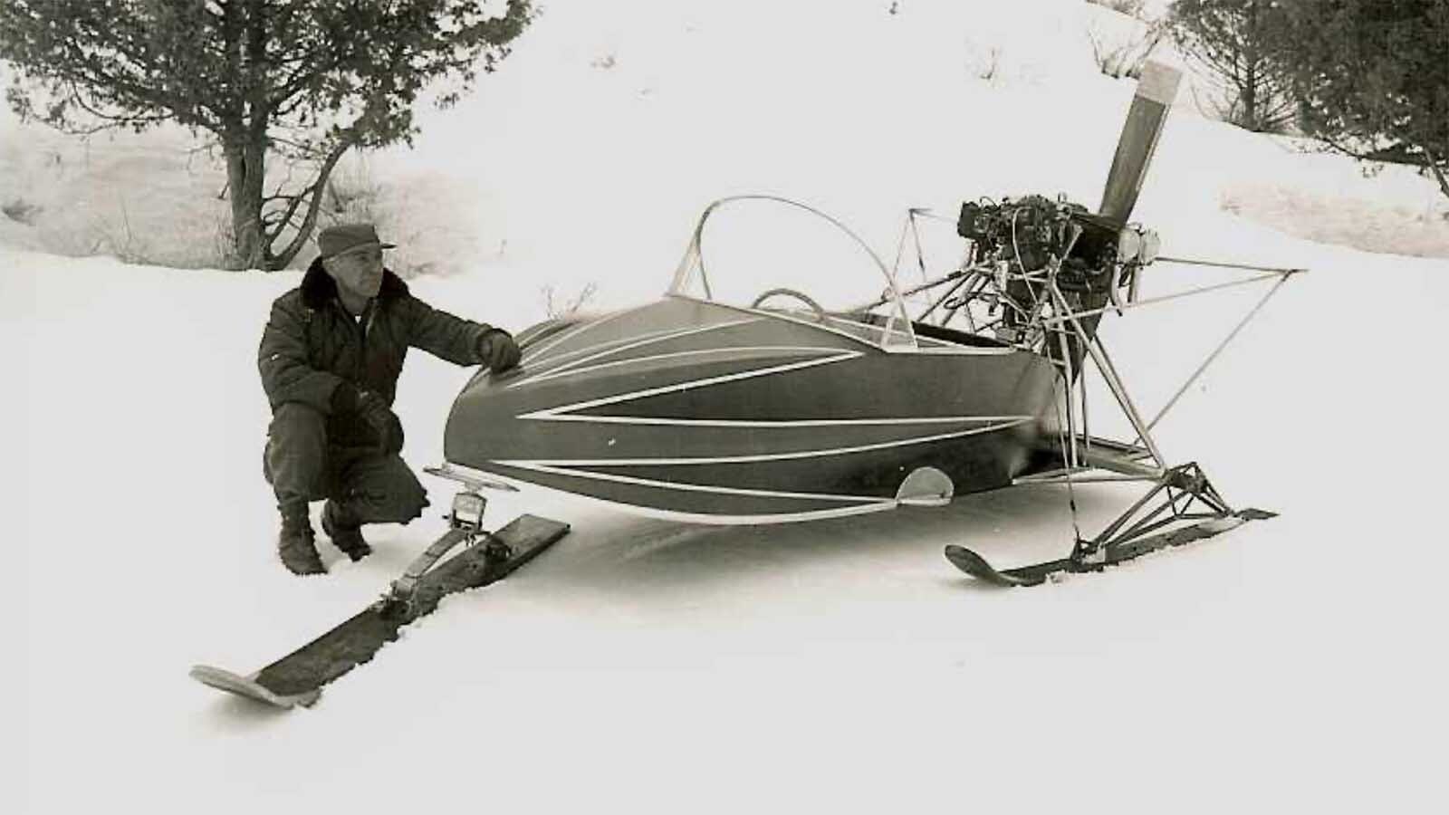 H.L. Wiese poses with an open cockpit snowplane.