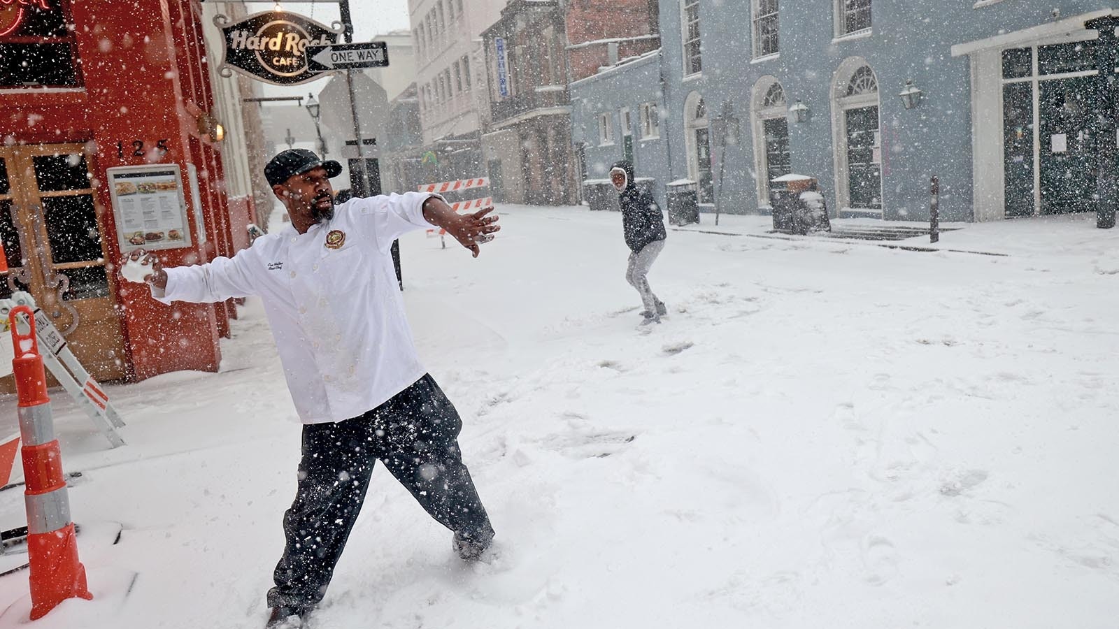 Sous chef Eric Walker engages in a snowball fight outside the Bourbon House Restaurant in the French Quarter on Jan. 21, 2025 in New Orleans, Louisiana.