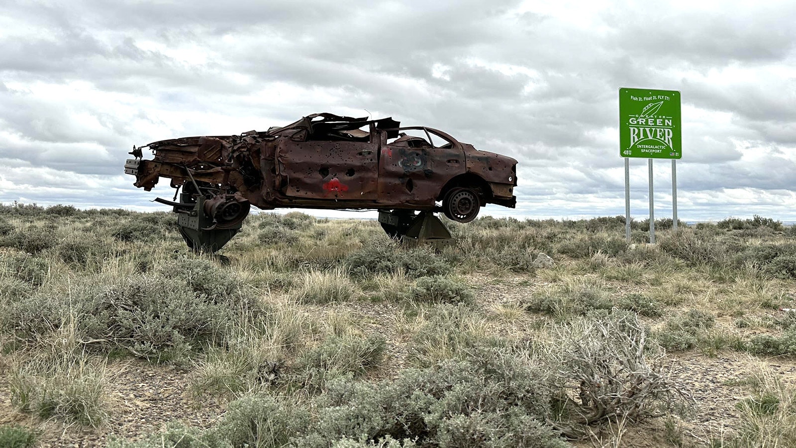 For some reason, a rusty wrecked car is perched near the Greater Green River Intergalactic Spaceport in southwest Wyoming. The bullet holes show that over the years, it's taken more than its fair share of pot shots.