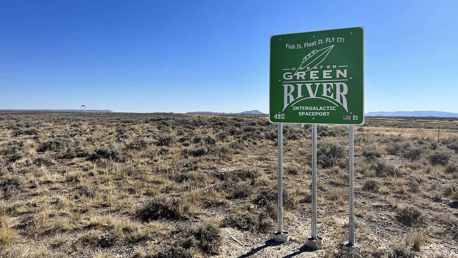A sign features a spacecraft coming in for a landing in Green River.