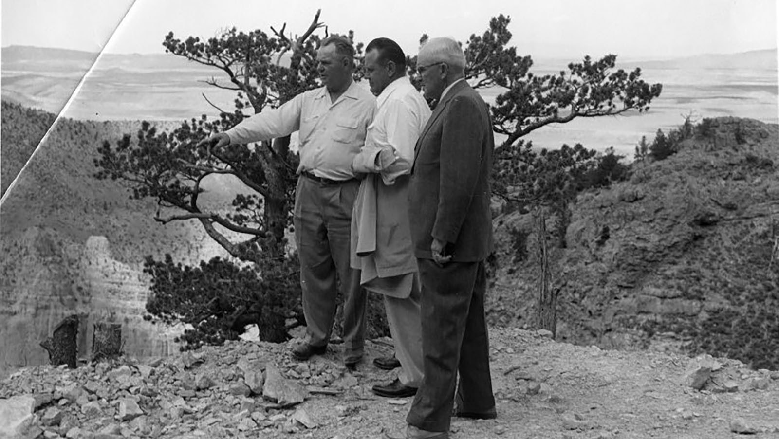 Claud Brown and two other men looking over the location for a tramway at Spirit Mountain Caverns on Cedar Mountain.