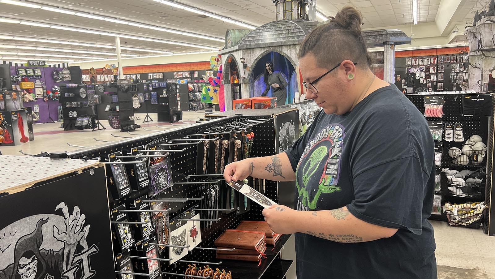 Kayla Hall checks out some spooky stickers at the Spirit Halloween store in Cheyenne on Thursday.