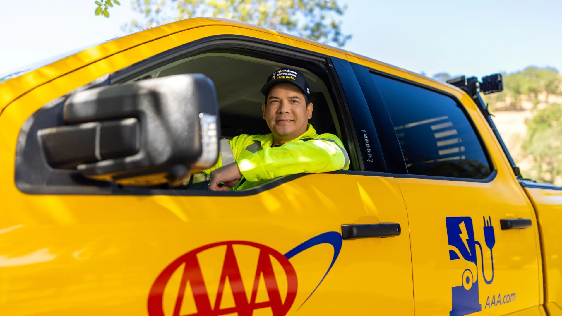 AAA driver with window down smiling.