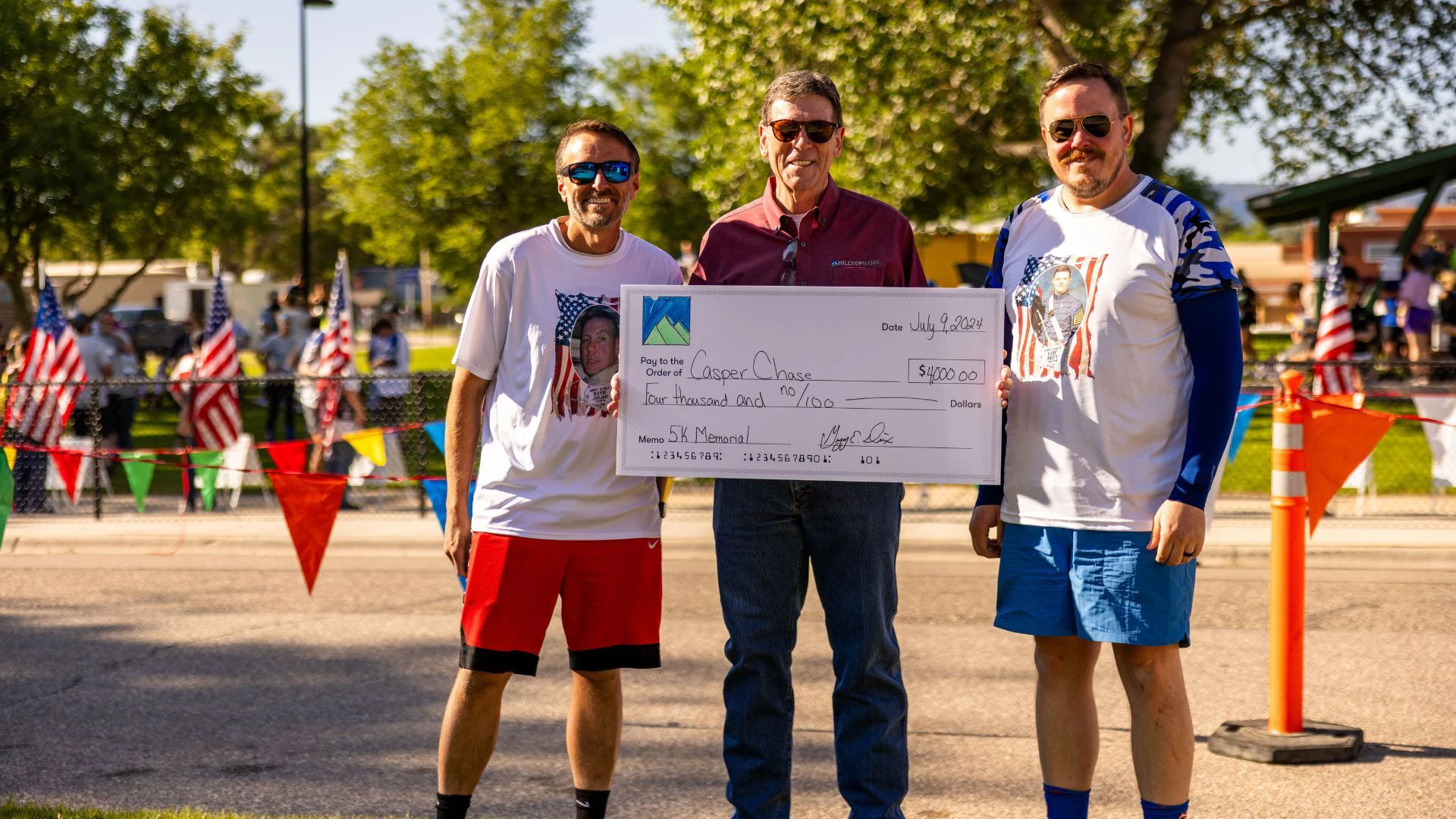 Hilltop Bank President and CEO, Greg Dixson, presents check at Casper Chase Fallen Soldiers Memorial 5K on July 9, 2024.