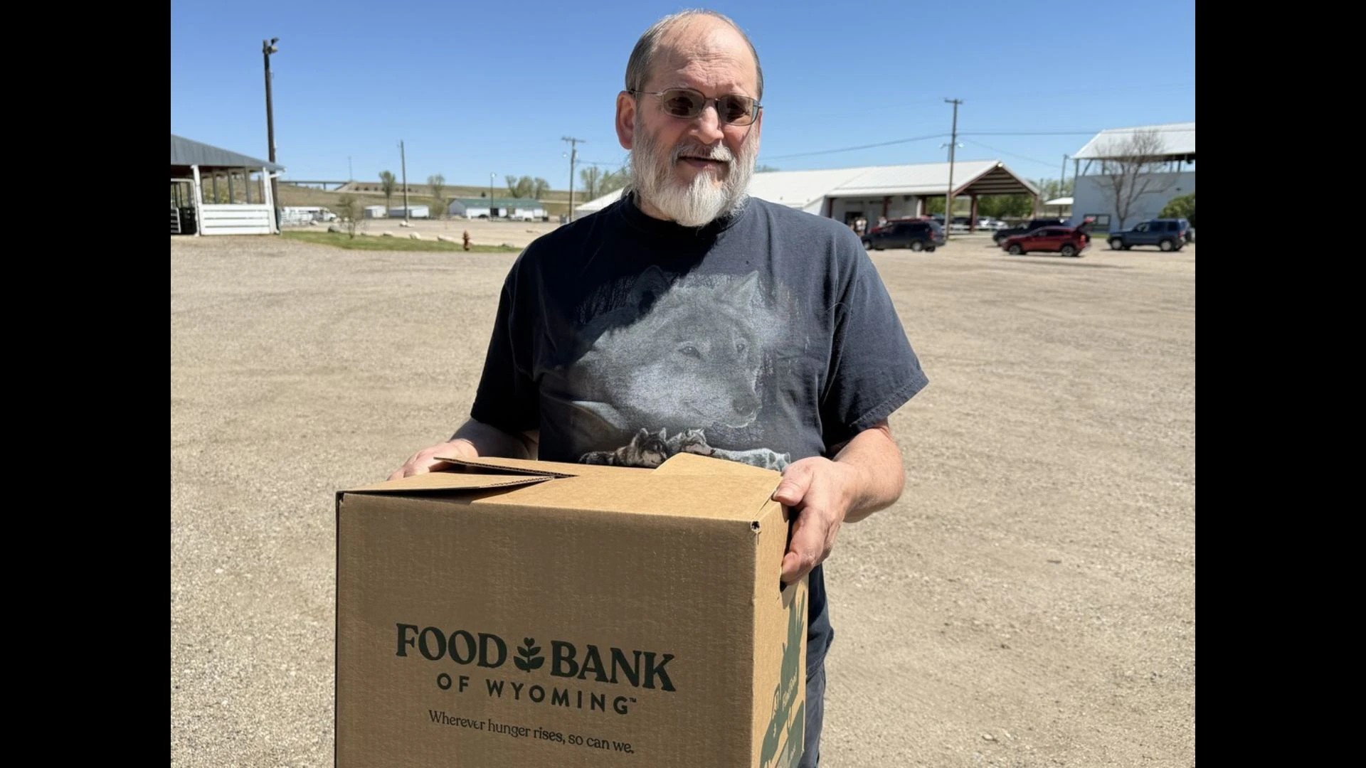 Man holding a Food Bank of Wyoming box.