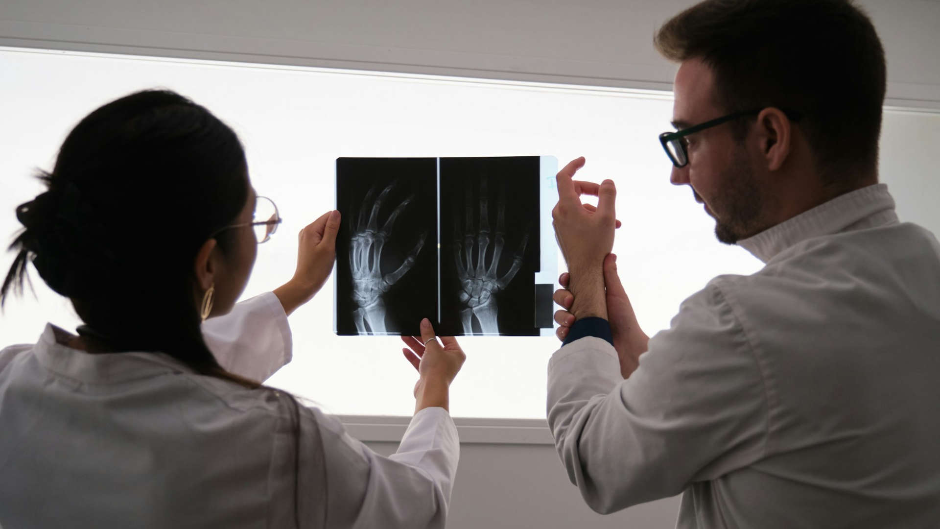 Two medical professionals are looking at an X-ray.