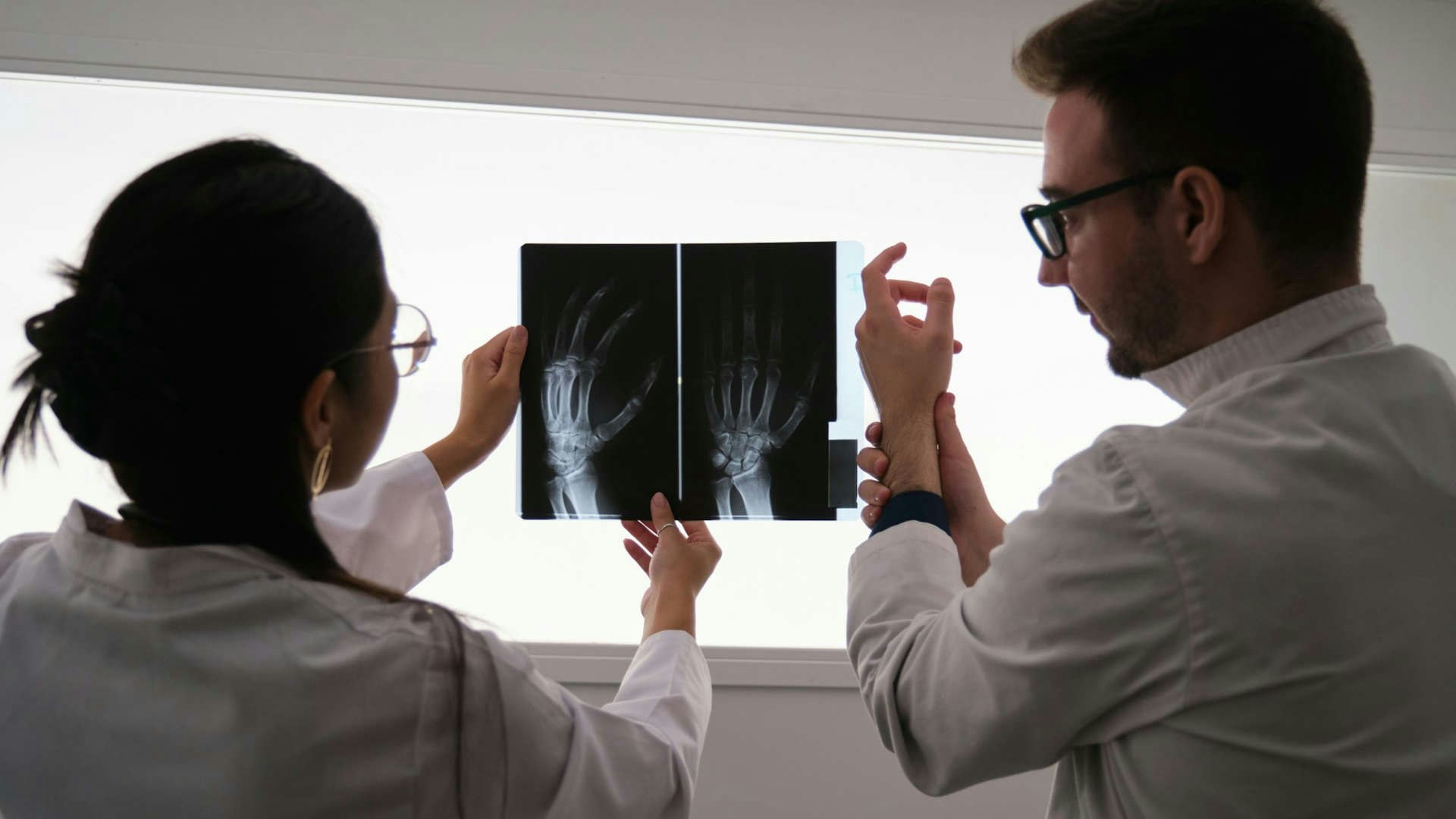Two medical professionals are looking at an X-ray.