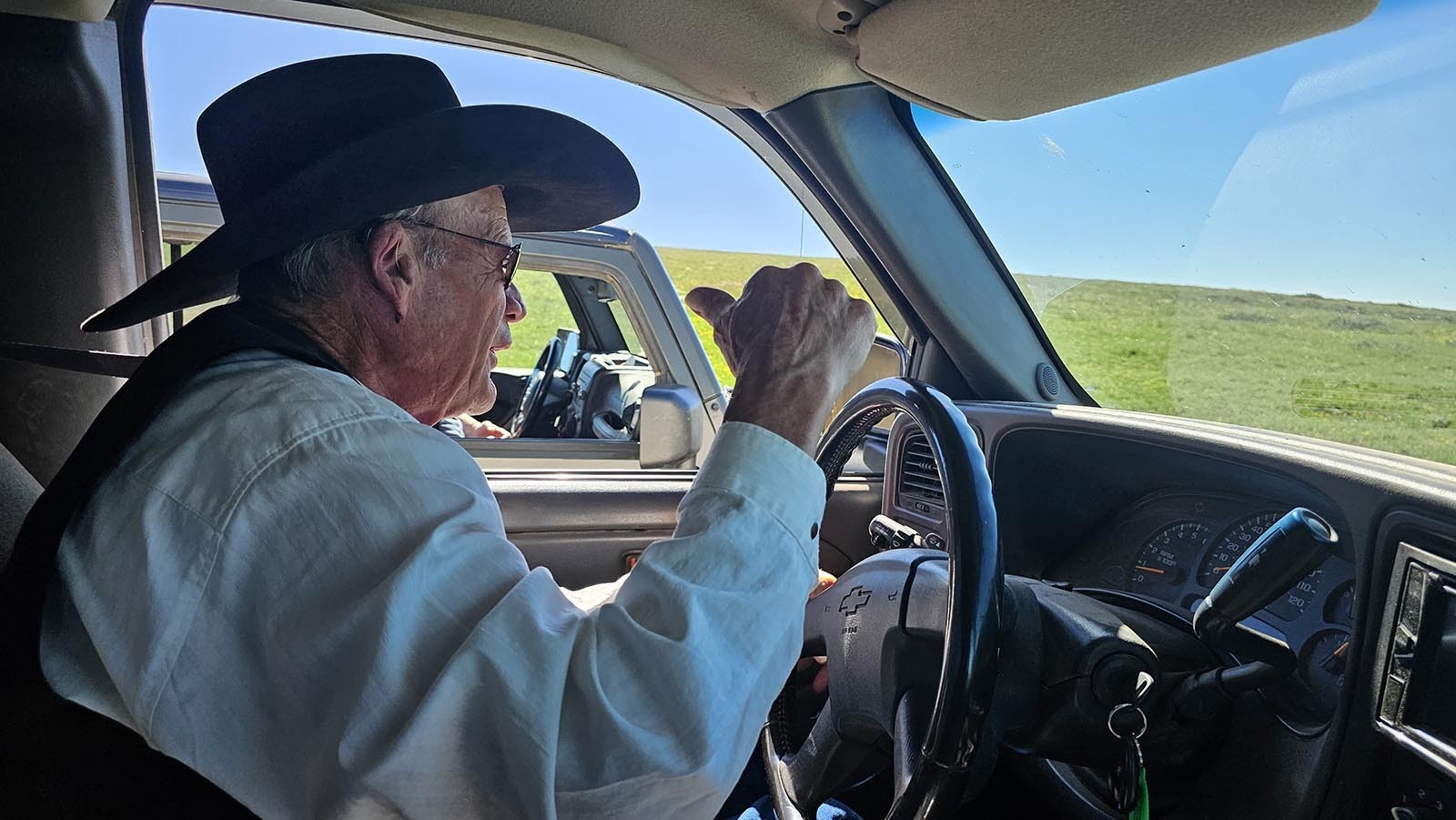 Clay Gibbons driving to the Hole in the Wall talks to a tour group in the vehicle to his left about what's ahead on the rugged roads.