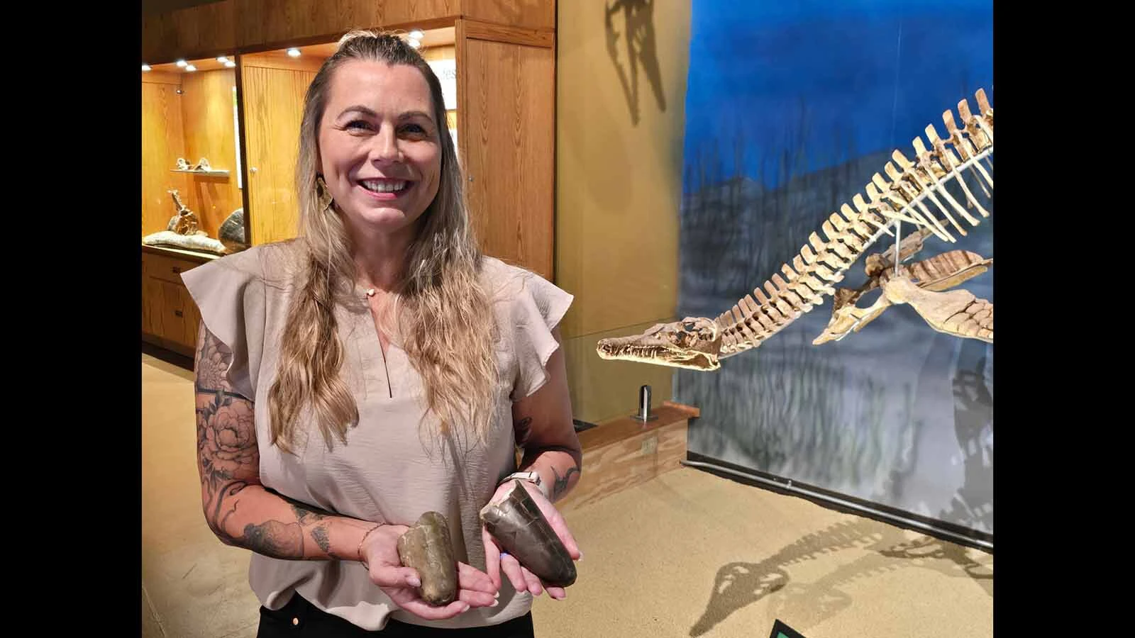 Paleontologist Jessica Lipponcott holds the only two specimens of the "chunky" squid Wyoteuthis linsterorum. Both fossils are on display at the Wyoming Dinosaur Center in Thermopolis.