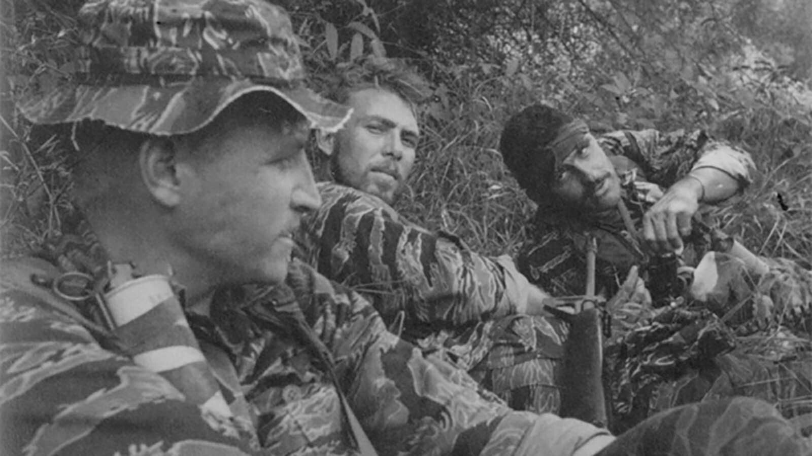 Staff Sgt. Drew Dix, center, and two members of U.S. Navy SEAL Team 2 rest after engaging the enemy during the reconnaissance operation they were conducting when the Viet Cong initially invaded the city pf Chau Phu.