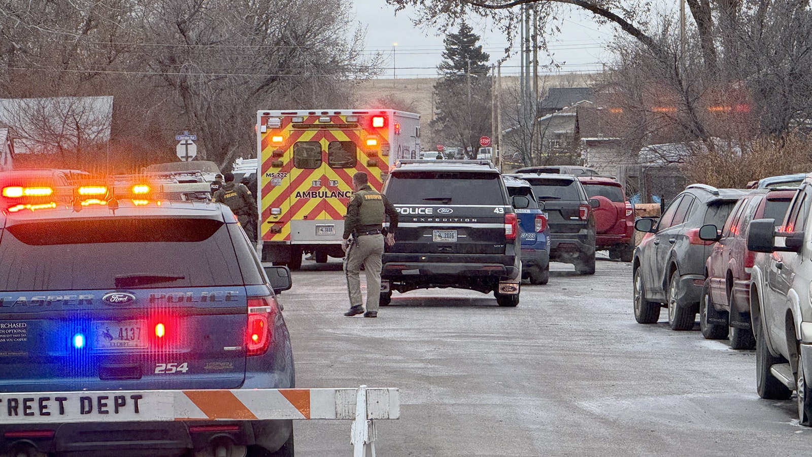 An ambulance pulls up to the house where an armed suspect was barricaded for more than 30 hours after a Sheridan police officer was shot and killed Tuesday.