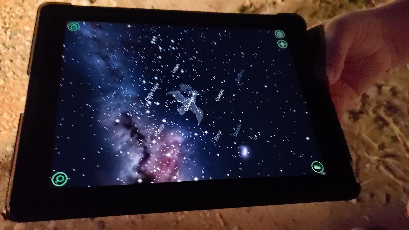 An iPad with an app that shows interesting things in whatever piece of sky its being pointed at. In this case since it's pointing at the ground and showing the starscape over China.