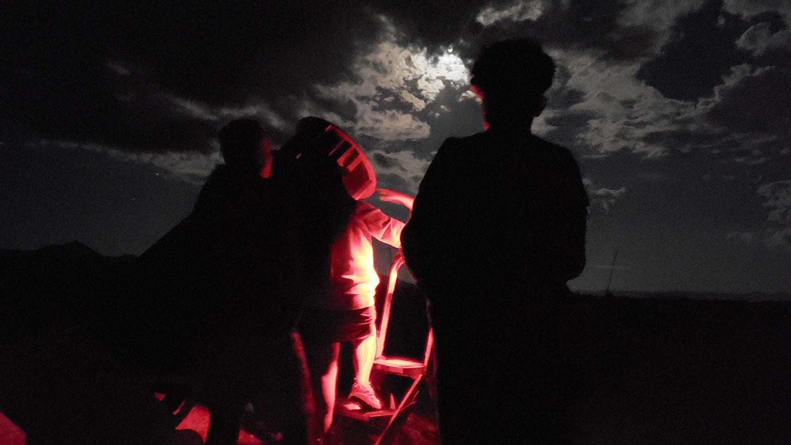 Tourists from Texas take turns looking at the star Vega through a telescope set up by Wyoming Stargazing on the edge of Grand Teton National Park.