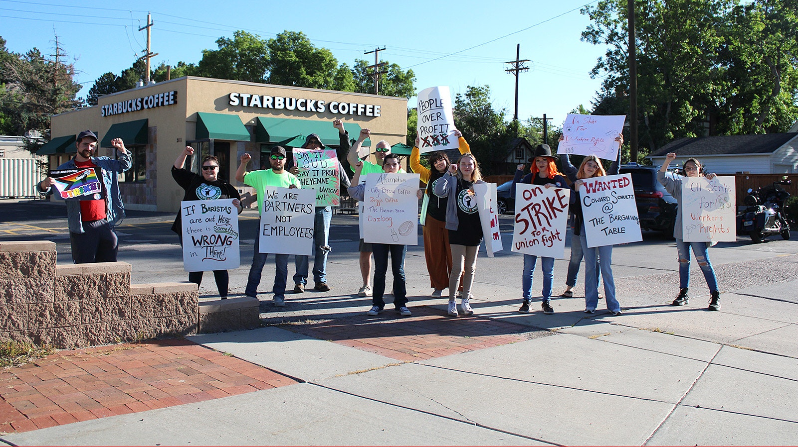 Striking Starbucks workers and their supporters gather at the store Sunday.