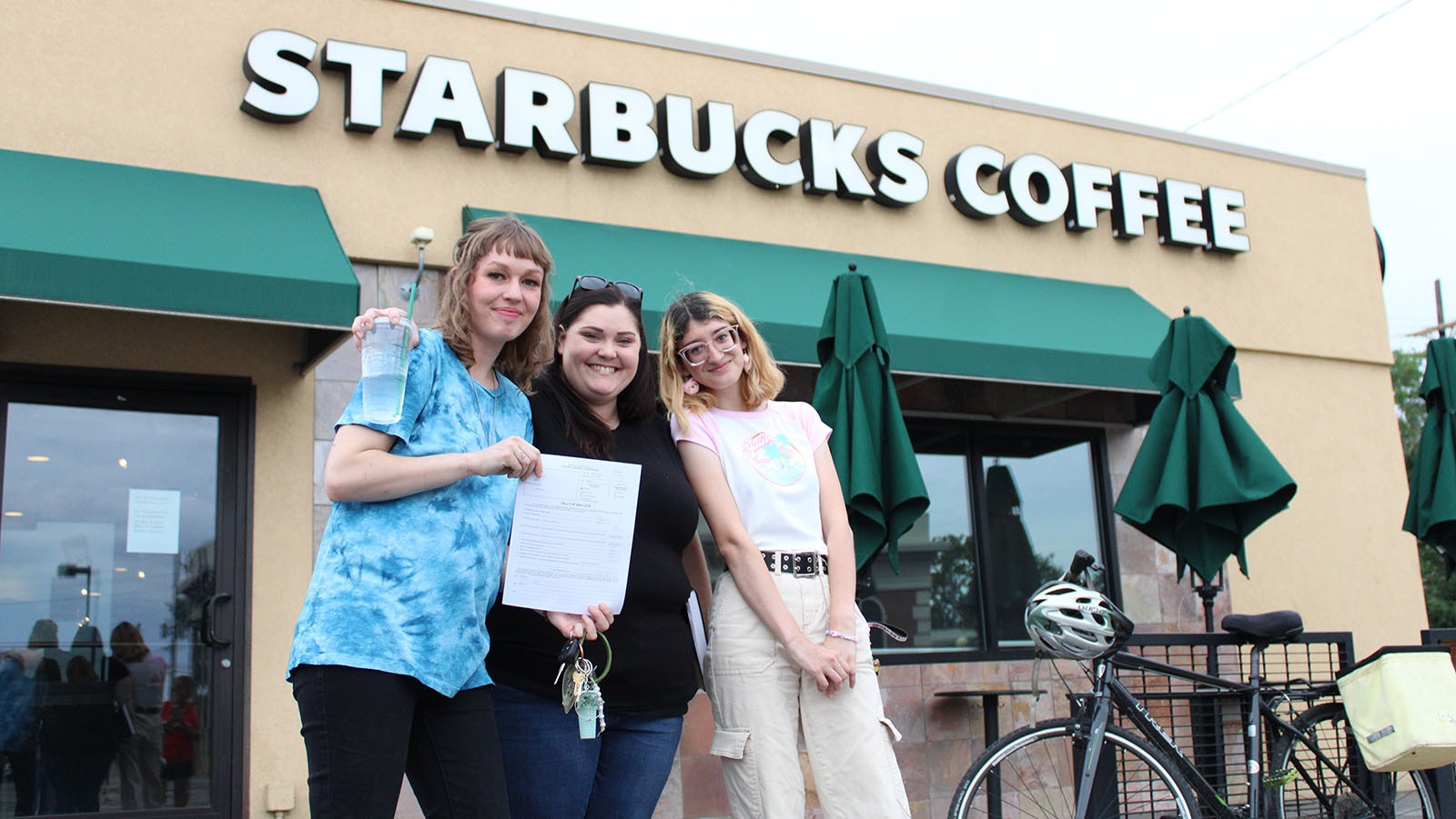 Pro-union Starbucks employees Madison Oats, from left, Christina Frakes and Evita Rojas hold the tally of votes showing majority support for unionization at a Cheyenne location.