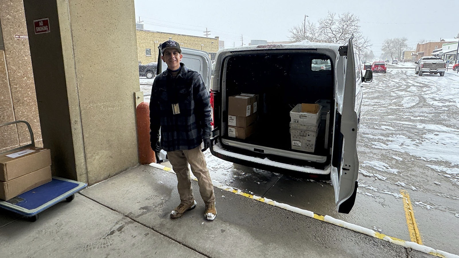 Danny Barela on Friday pauses for a break on the loading dock of the Hathaway Building along Capitol Avenue after making a stop with one of Wyoming’s two electric-powered cargo vans.