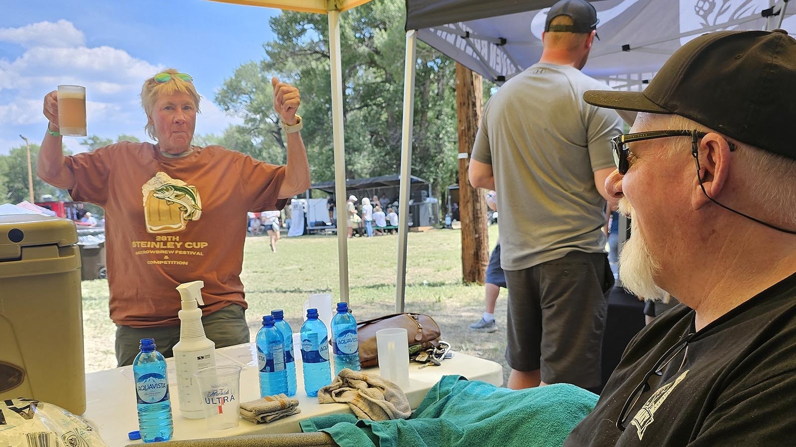 Mitch Kunce, right, brewer at The Library in Laramie, talks with a fan of his blueberry-pomegranate beer at the annual Steinley Cup Microbrew Festival in Saratoga.