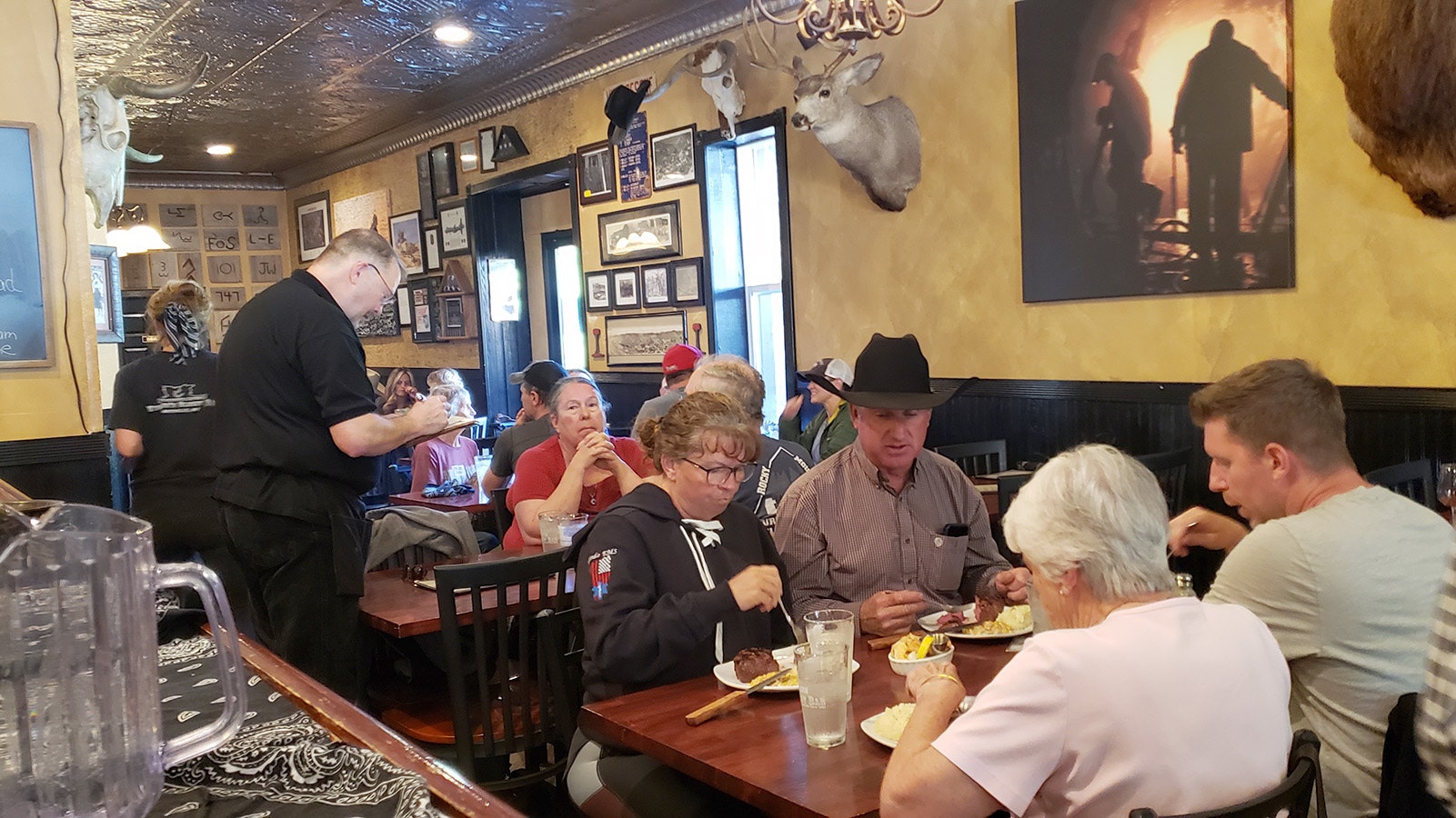 Waiter Michale Thompson, a one-time history teacher, takes orders at the busy Miners and Stockmen's Steakhouse in Hartville.