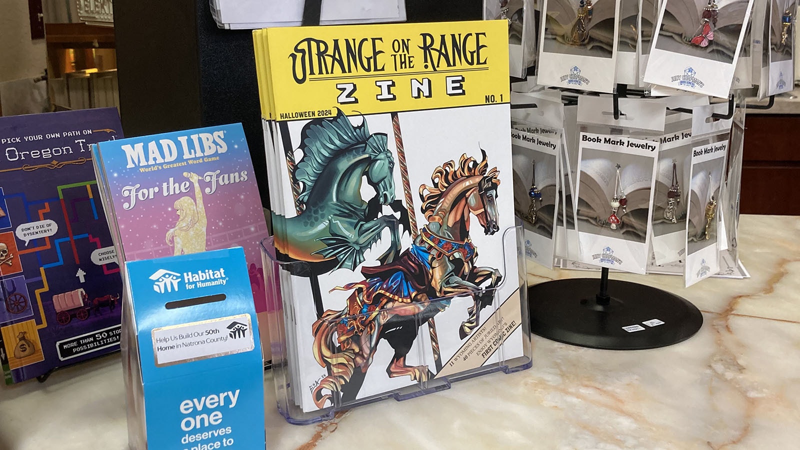 Strange on the Range is available in hard copy at Wind City Books and Art321 in Casper.