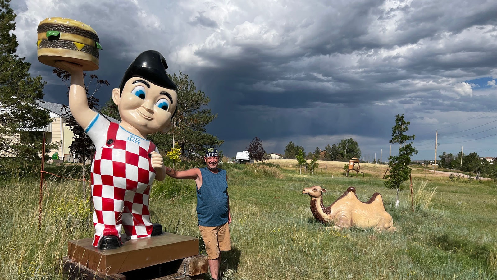 Stuart Flynn poses with his Bob's Big Boy and camel statues along Yellowstone Road just north of Cheyenne city limits.