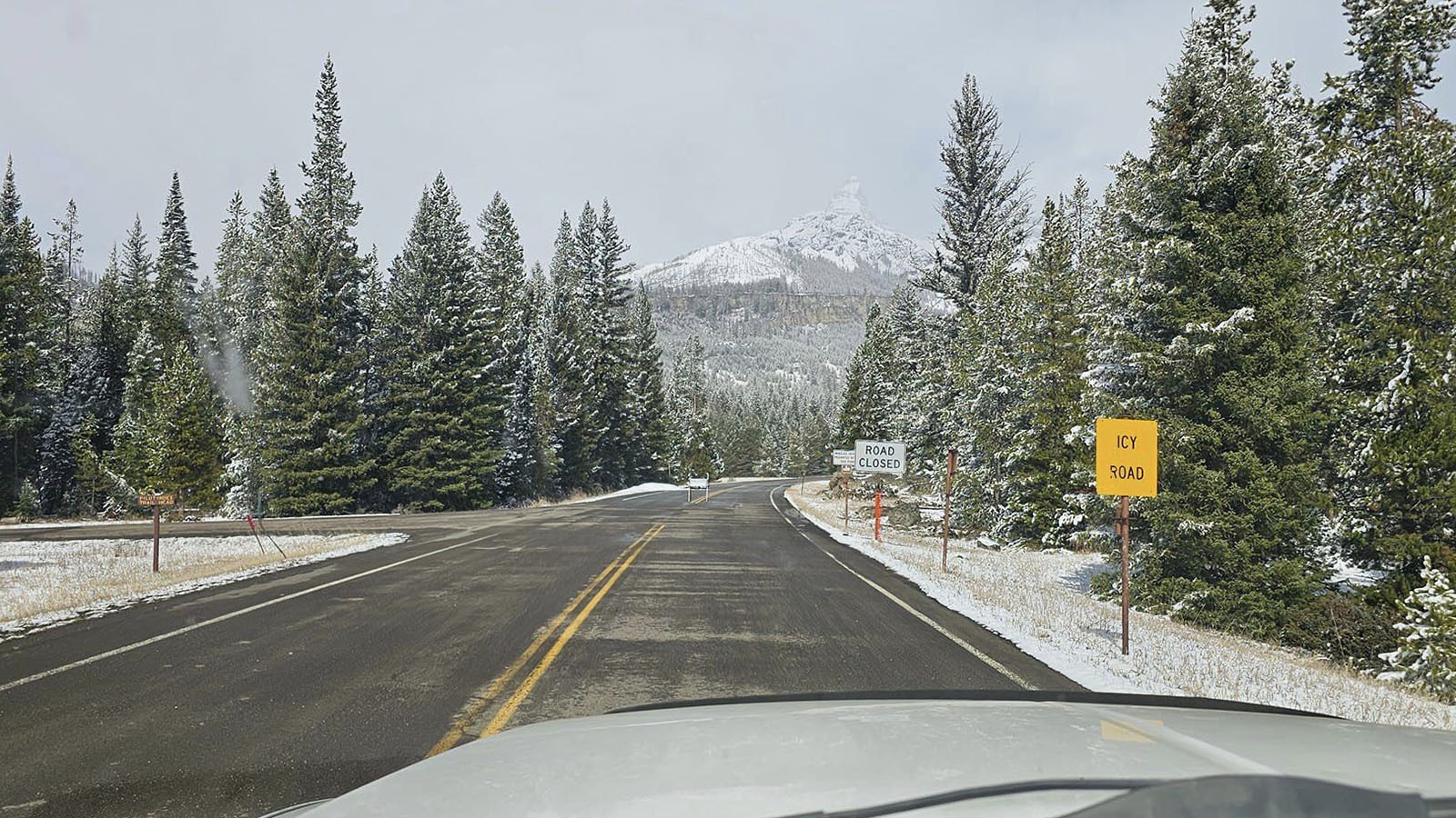With the sun shining, the signs on Highway 212 near Yellowstone proclaim the road is still closed for the season.