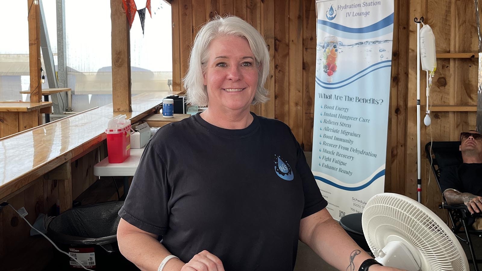 Stacy Kenitzer, 56, stands outside her booth for Hydration Station IV Lounge at the Sturgis Thunderdome.