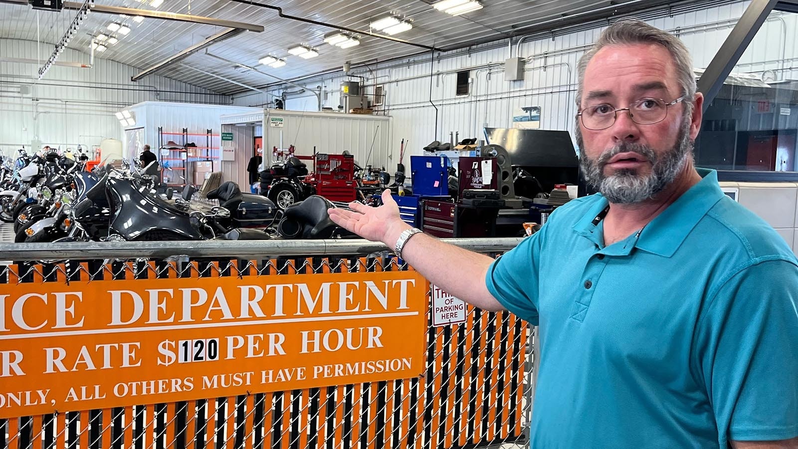 Deluxe Harley-Davidson Business Manager Bryce Cowen points to the service department that has staffed up to handle Sturgis rally customers.