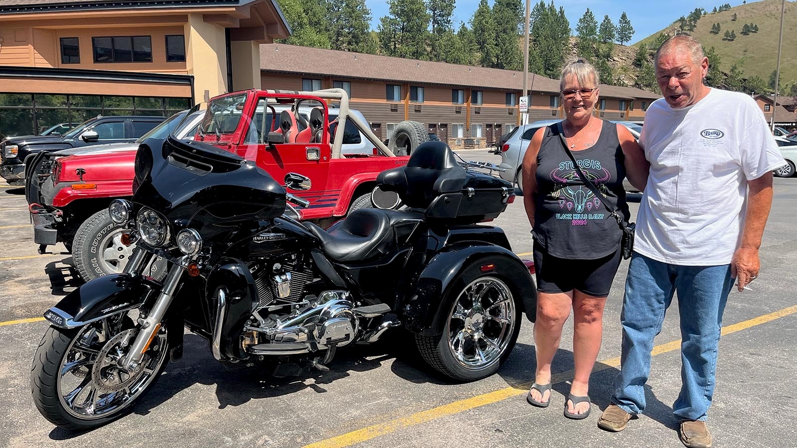 Rob Gleghorn and Toni Moore stand beside their 2021 Harley-Davidson Electra Glide Trike. The Pennsylvania couple are in Sturgis, South Dakota, for the annual motorcycle rally.