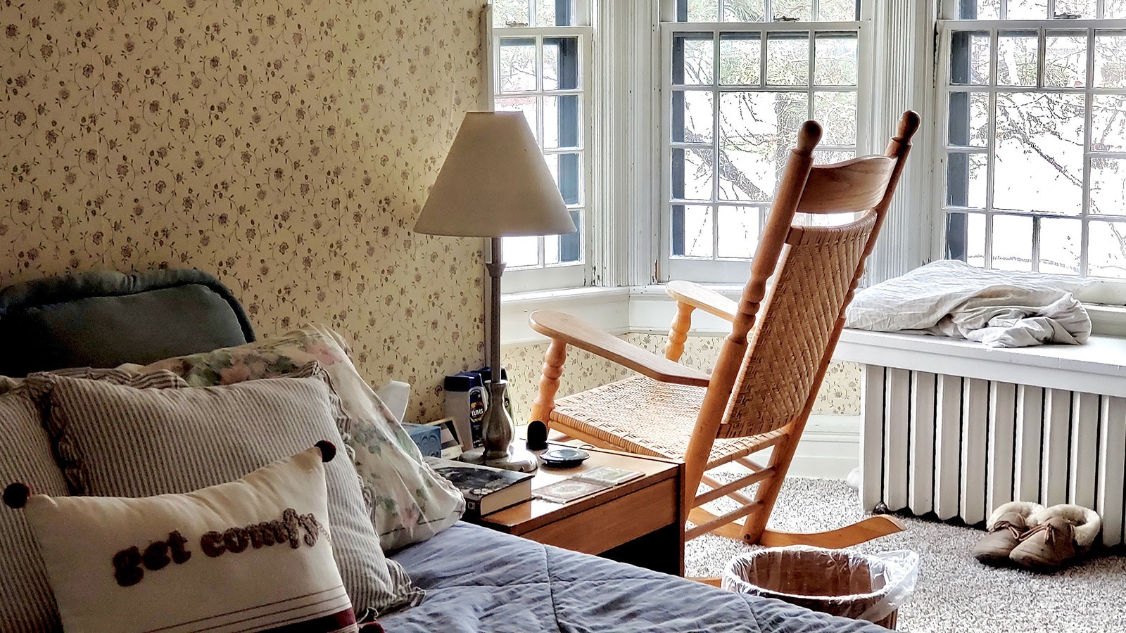 The master suite in the Sturgis House has a turret to the right of the bed that overlooks the yard outside while the radiator features a wooden bench for sitting.