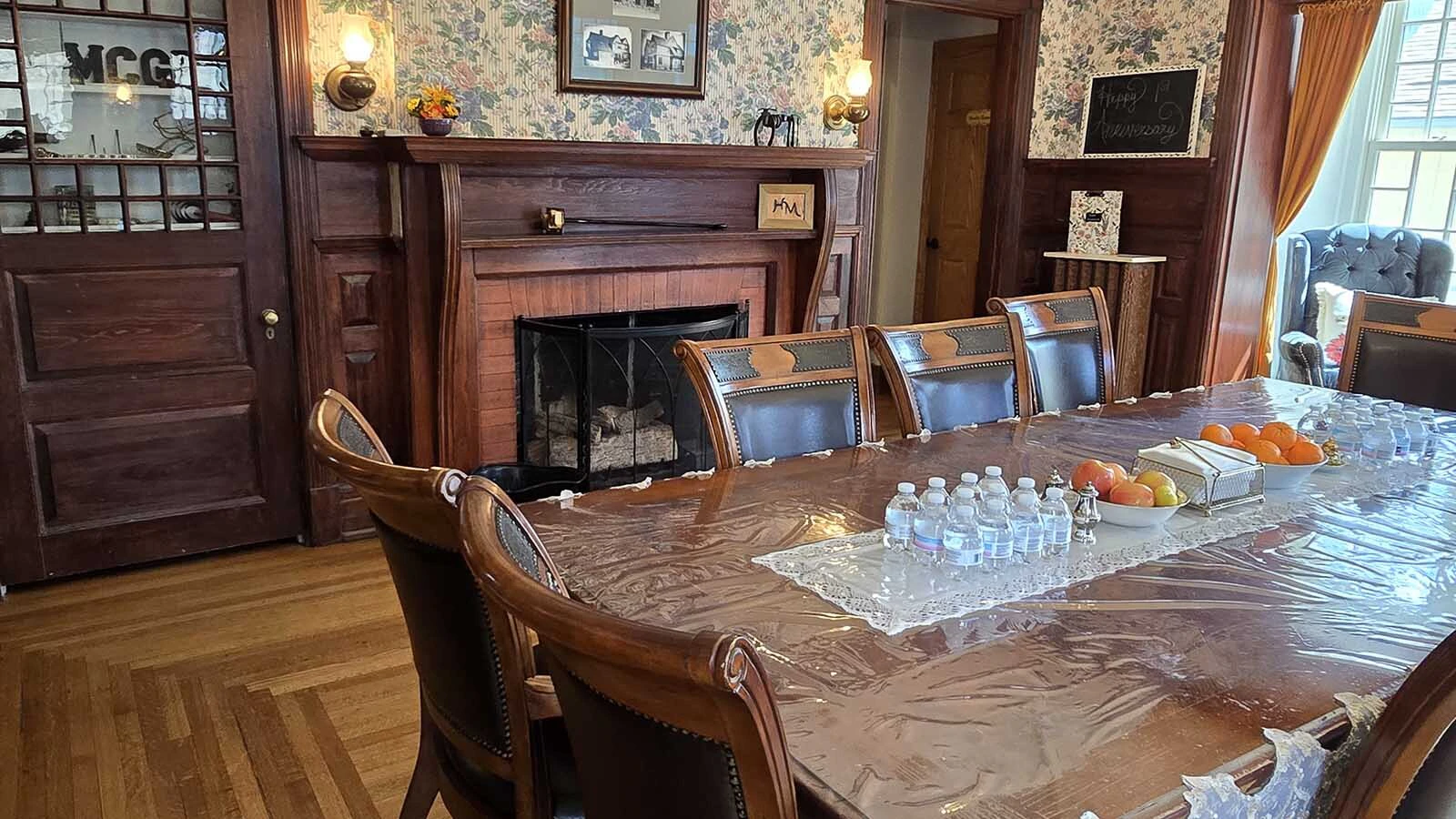 The dining area in the Sturgis Mansion looks much as it did before, but with fresh wallpaper and decor.
