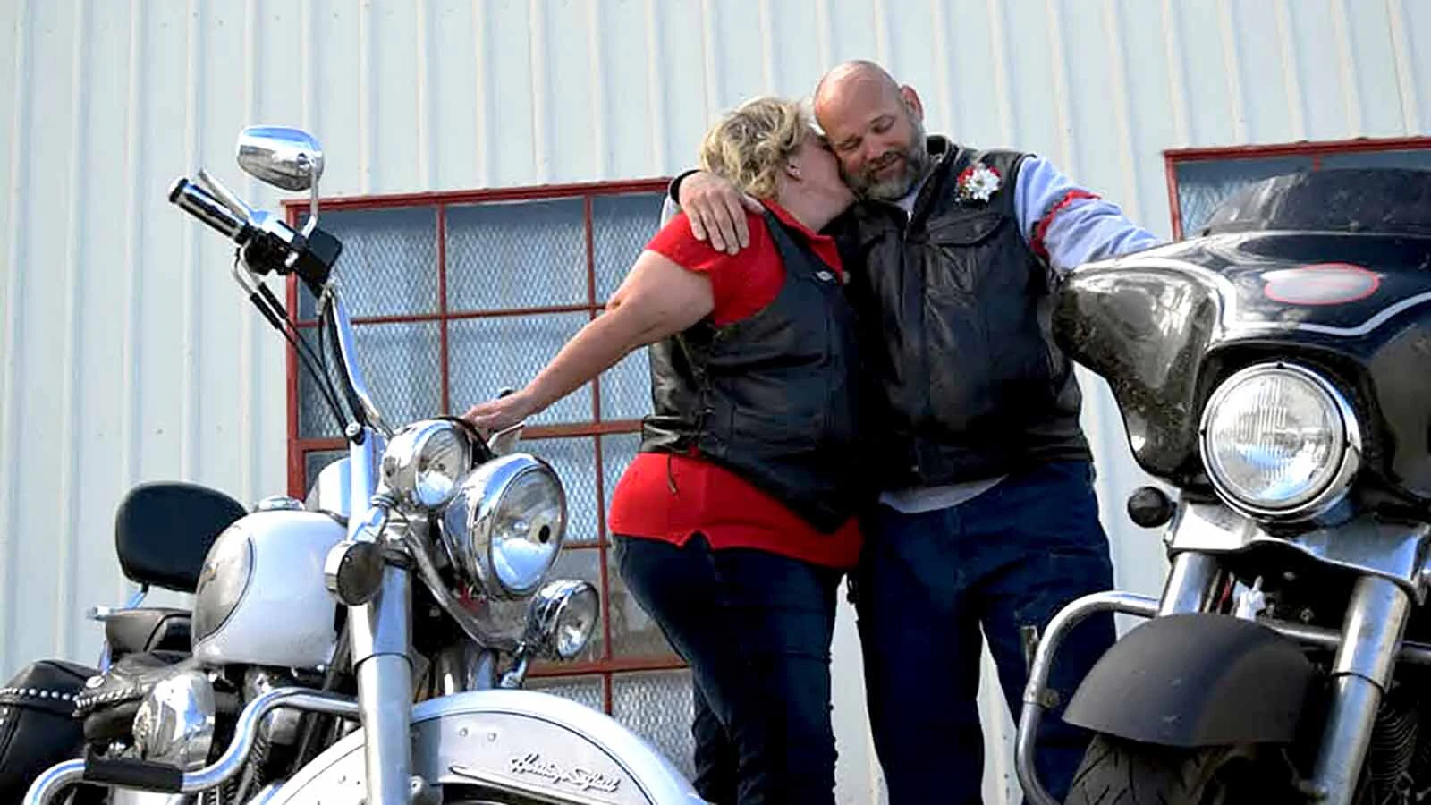 Pretty Bobbie gets a kiss from his “old lady” beside their motorcycles.