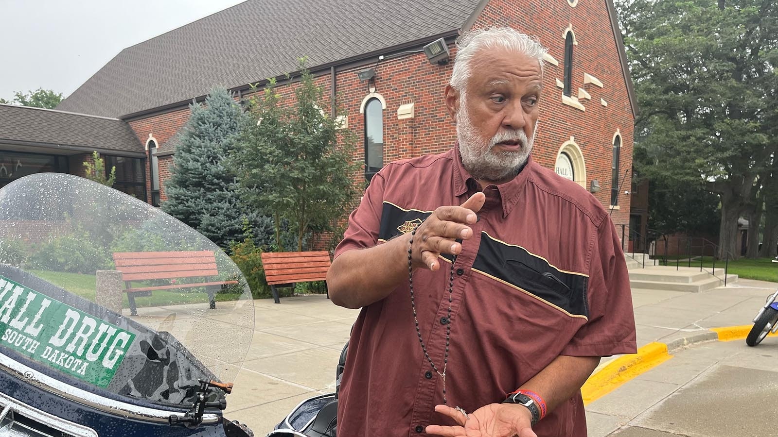 Horacio Vela stands near his Harley-Davidson after Catholic Mass on Sunday. Vela carries a rosary with him as he rides.