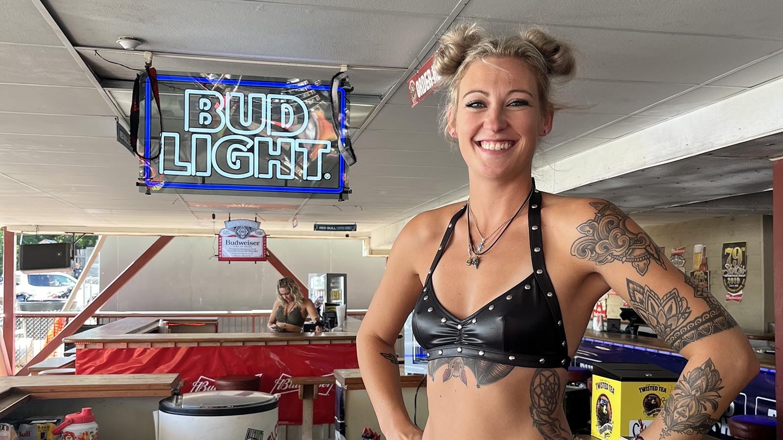 Cassey Weinhold, 28, stands at the bar she minds for the One-Eyed Jack Saloon in Sturgis. Weinhold came from Kansas to work the rally. The earnings help her throughout the year.